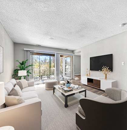 A modern living room with a large window, a flat screen TV, and a coffee table.
