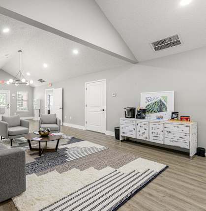 a living room with couches and chairs and a dresse at 445 Cleveland Apartments in Atlanta, Georgia, 30354