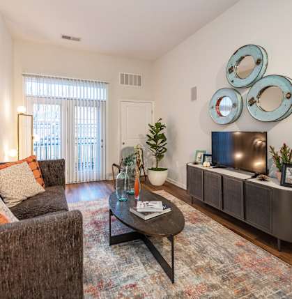 A living room with a brown couch and a coffee table.