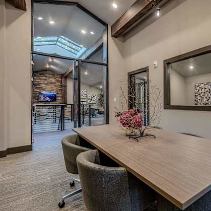 A conference room with a long table and chairs.