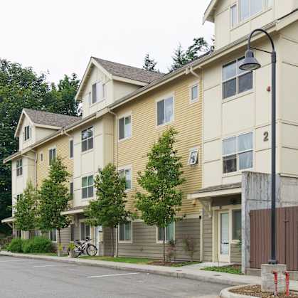 Apartment building with a bicycle parked in front.