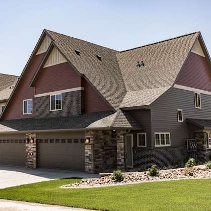 Bismarck, ND Stonefield Townhomes |a large house with a garage and a driveway