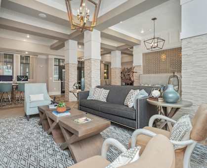 a living room with couches and chairs and a table at Residence at Riverwatch in Augusta, GA 30909