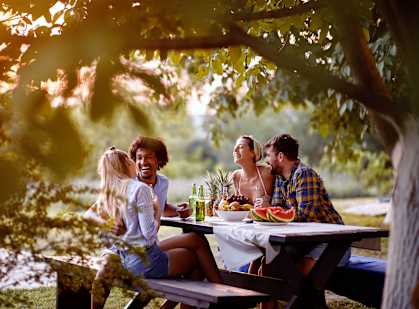A group of people enjoying a meal together outdoors.