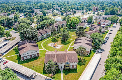 A bird's eye view of a residential area with houses and a playground.