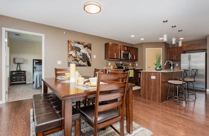 A modern dining room with a wooden table and chairs.