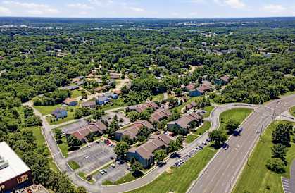 A bird's eye view of a residential area with houses and a road.