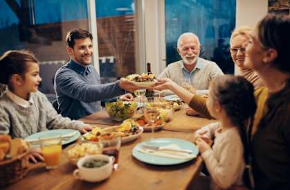 Group of people sitting around a table eating food at Regency Park Apts, El Centro, CA 92243
