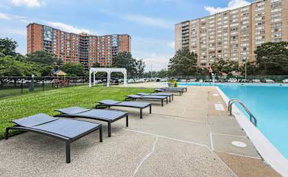Sun lounge chairs beside pool at Monticello at Southern Towers, Alexandria