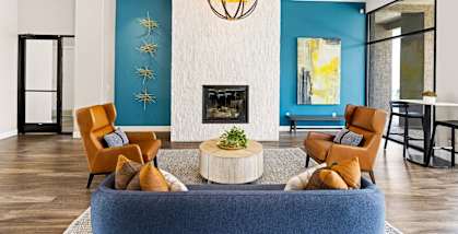 A living room with a fireplace and a chandelier.