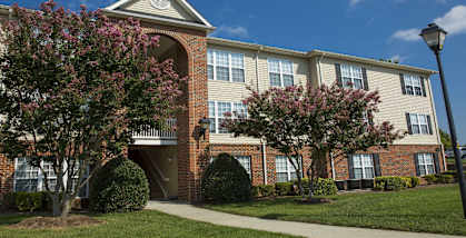 A building with a brick facade and a white trim around the windows.