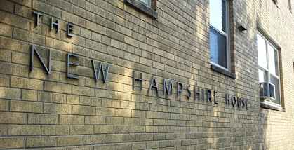 a brick wall with the name of the new haven trust on it