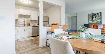 a dining room and kitchen with a table and chairs at The Waters at Chenal, Little Rock, Arkansas