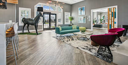 A living room with a giraffe statue in the middle.
