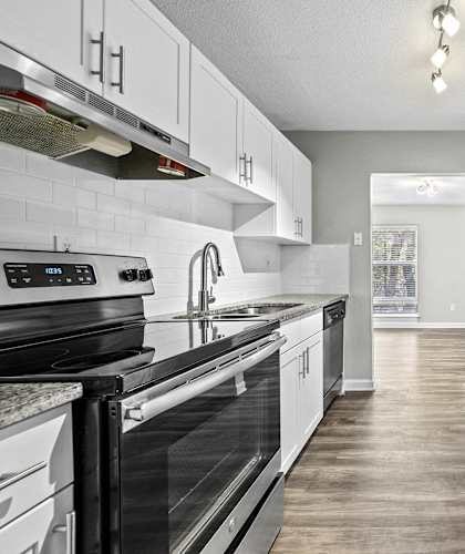 a kitchen with stainless steel appliances and white cabinets