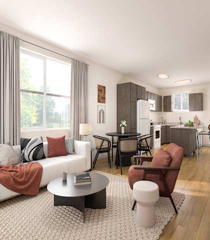 A modern living room with a white sofa, a coffee table, and a television.