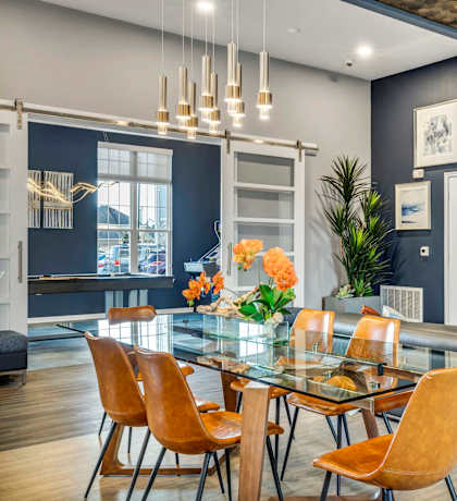 a dining room with a glass table and a couch