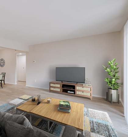 A living room with a grey sofa and a wooden coffee table.