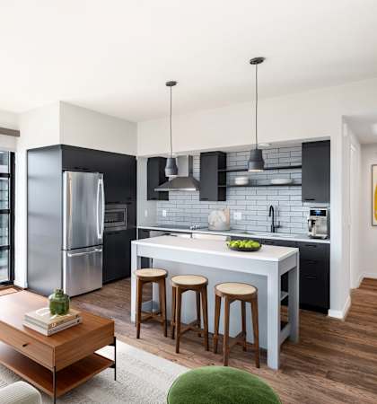 a living room with a kitchen and a couch and a table