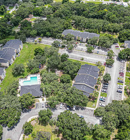 an aerial view of a neighborhood of houses and a swimming pool