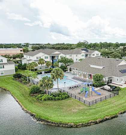 an aerial view of a resort with a swimming pool