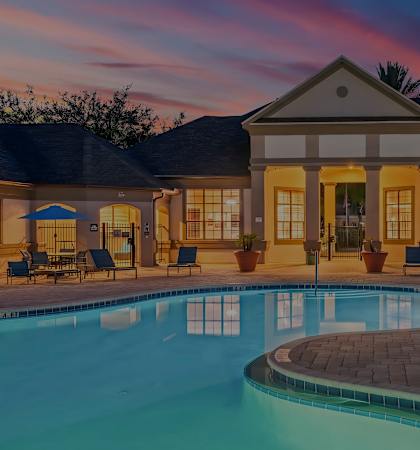 Resort-style swimming pool at dusk - Delano at Cypress Creek