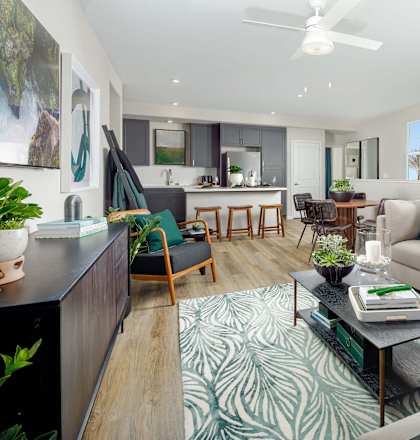 A living room with a couch, chairs, and a coffee table.