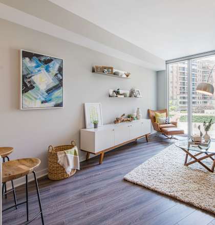 a living room with hardwood floors and a large window