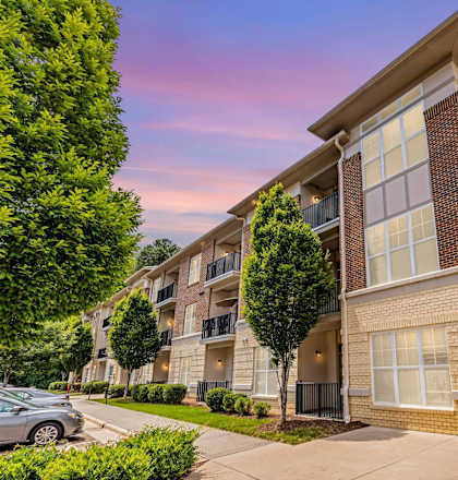 A modern apartment building with a brick facade and balconies.