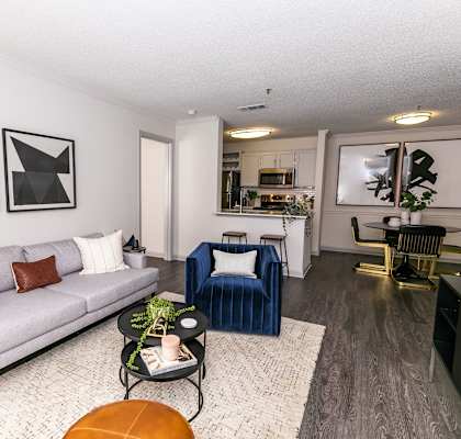 a living room with a couch and two chairs  at Briarcliff Apartments in North Druid Hills, Georgia