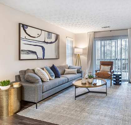 a living room with a couch and a tv at Gwinnett Pointe in GA 30093