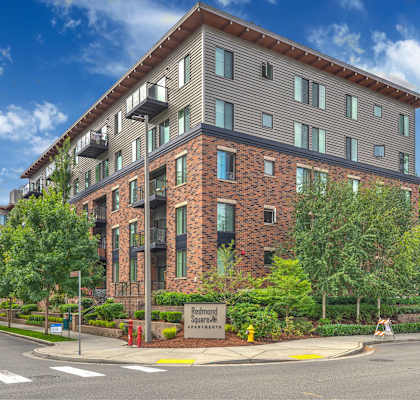 A multi-story building with a brick facade and a sign that reads "Bedford Park".