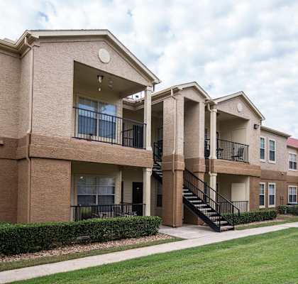 Apartment complex with a green lawn in front. at Infinity on Sunnyvale Apartments , Mesquite, 75150