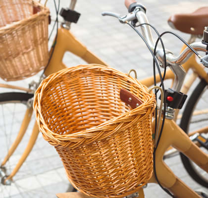 a yellow bike with two wicker baskets on the front
