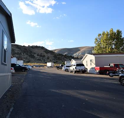 a parking lot in a trailer park with mountains in the background at Horizon MHC, Rock Springs, WY 82901