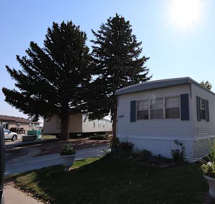 the exterior of a mobile home on the side of a street at Kimberly Village, Cheyenne, Wyoming