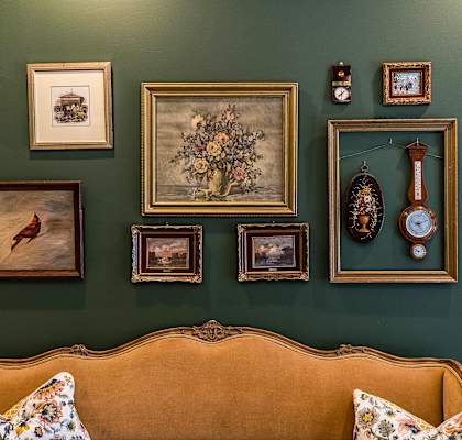 A living room with a couch and pictures on the wall.