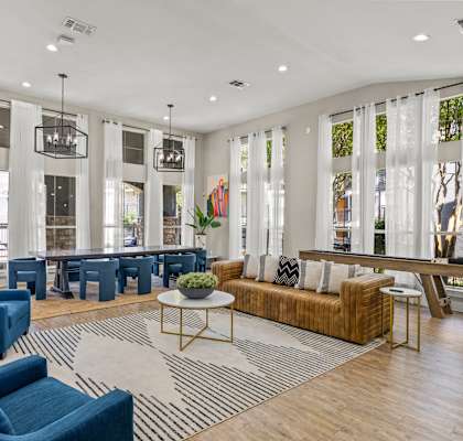a living room with couches and chairs and a table at District 2308, Arlington Texas