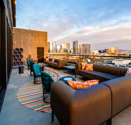 a roof top bar with a view of the city