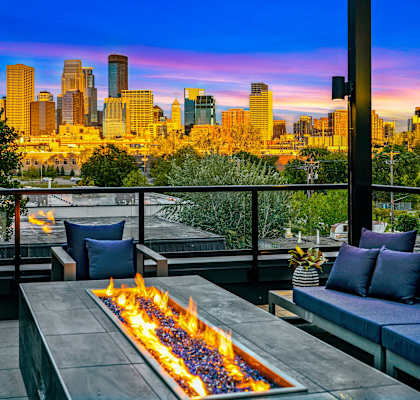 the view of the skyline of the city from a patio with a fireplace