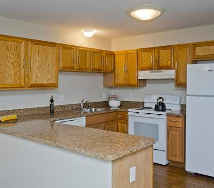 a kitchen with white appliances and granite counter tops