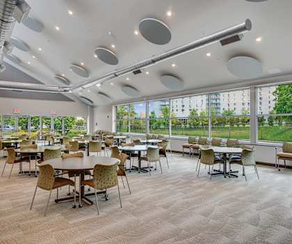 A room with tables and chairs and a lot of windows at Independence Place Apartments, Ohio