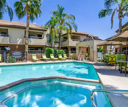 The outdoor pool with pool chairs, tables, and chairs at Desert Horizon. 