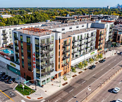 An aerial shot of the exterior of 4800 Excelsior, showing the windows, pool, and street.