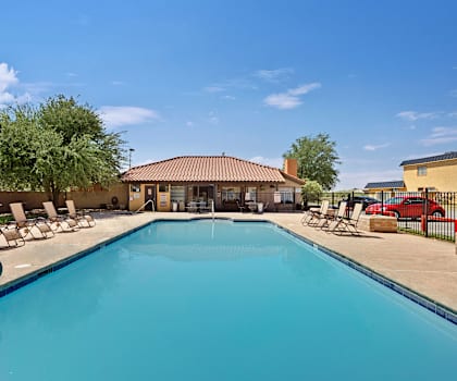 Turquoise pool with chairs at Avanti Townhomes. 