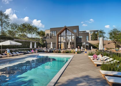 A large swimming pool with people relaxing on the side.