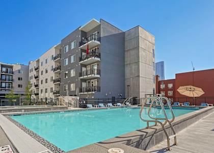 a swimming pool with a building in the background