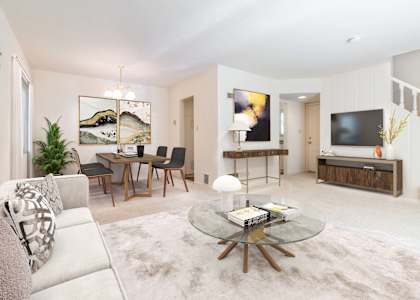 A modern living room with a glass coffee table and a white sofa at Hillsdale Garden Apartments, San Mateo, CA