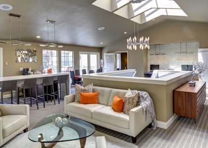 a living room with a couch and a kitchen with a bar at 2000 Lake Washington Apartments, Renton, WA, 98056