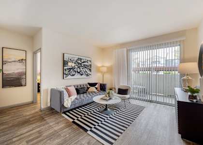 an open living room with a couch and a coffee table at Paisley and Pointe Apartments, Las Vegas, Nevada